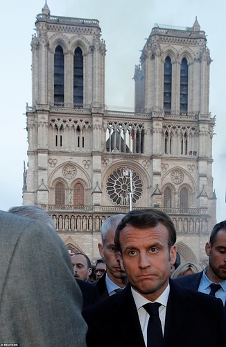 12311970-6925015-a_visibly_upset_emmanual_macron_walking_near_the_notre_dame_cath-a-272_1555359075088